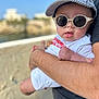 Liham participe au concours pour gagner de l'argent avec cette photo : arm, baby, blurred_background, cap, casual, child, cute, daylight, face, fashion, hand, holding, outdoor, person, portrait, shirt, skin, summer, sunglasses, sunlight