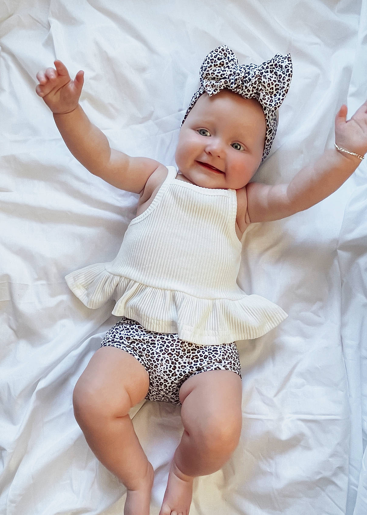 Hadleigh is registered to the contest to win money with this photo: baby, baby_toddler_clothing, comfort, eye, finger, gesture, hand, happy, head, headgear, headwear, human_body, person, pink, skin, sleeve, smile, textile, thigh, thumb