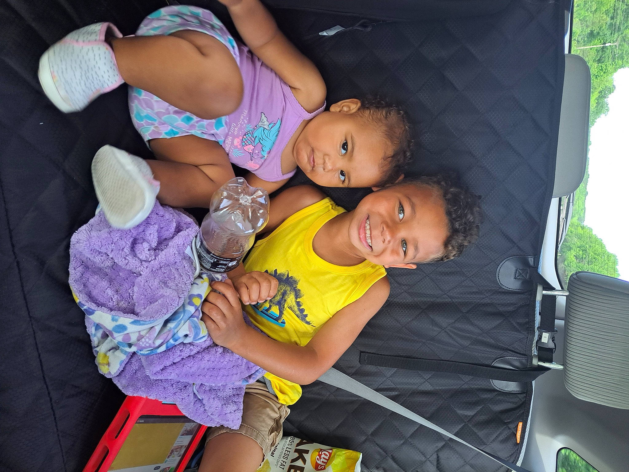 Xara is registered to the contest to win money with this photo: abdomen, automotive_exterior, chest, child, clothing, event, fun, happy, human_leg, joy, knee, leg, leisure, motor_vehicle, mouth, person, shorts, smile, t_shirt, thigh