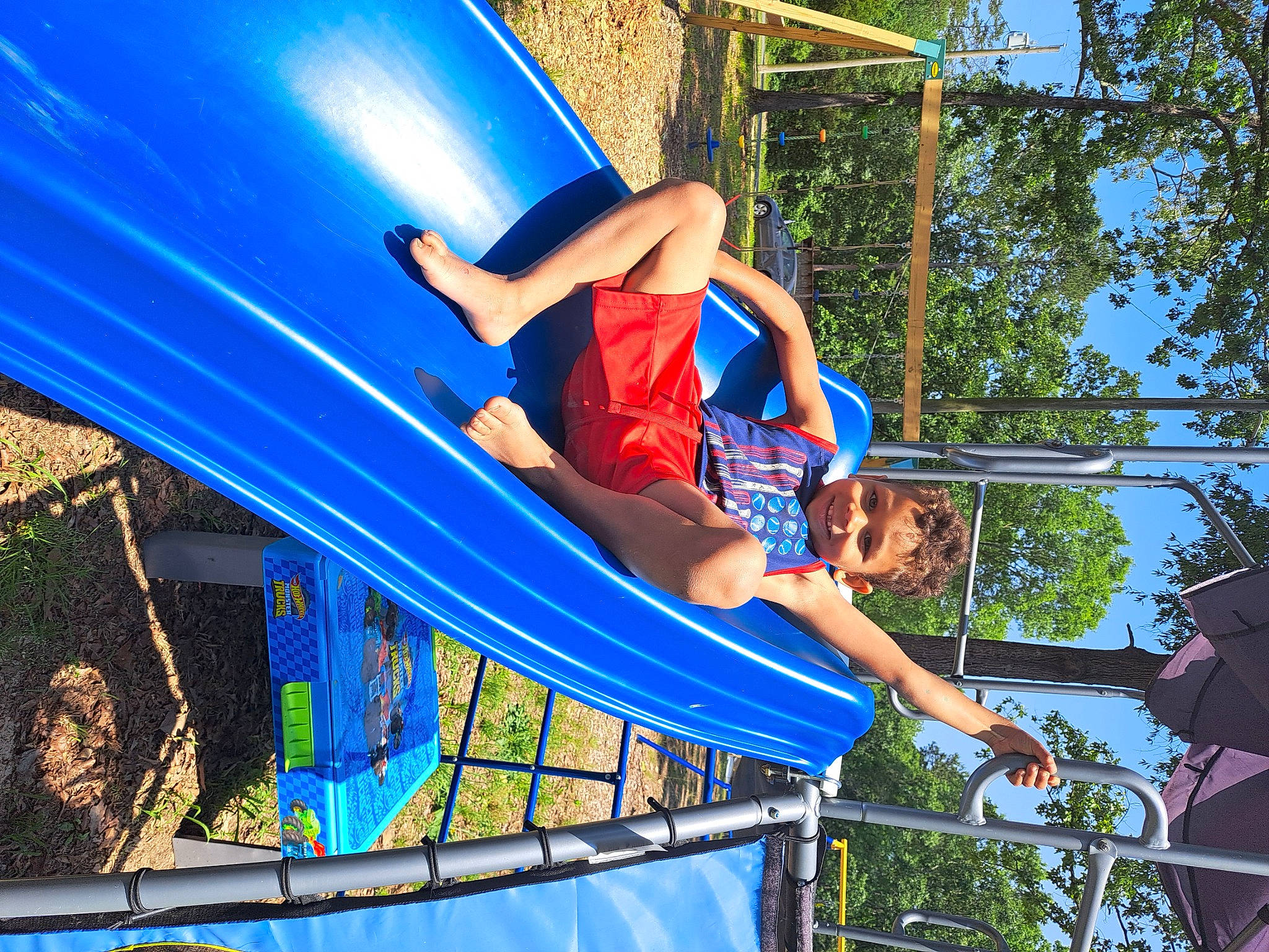 Xekial is registered to the contest to win money with this photo: amusement_park, amusement_ride, chute, city, electric_blue, fun, human_leg, human_settlement, joy, leisure, nonbuilding_structure, outdoor_play_equipment, person, playground, pole, public_event, recreation, shorts, sky, smile