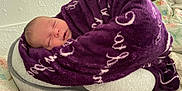 Taegan joined the competition — help win amazing prizes! baby, blanket, purple, sleeping, infant, face, cushion, bed, soft, cozy, indoor, person, child, wrapped, head, rest, home, comfort, peaceful, sleep