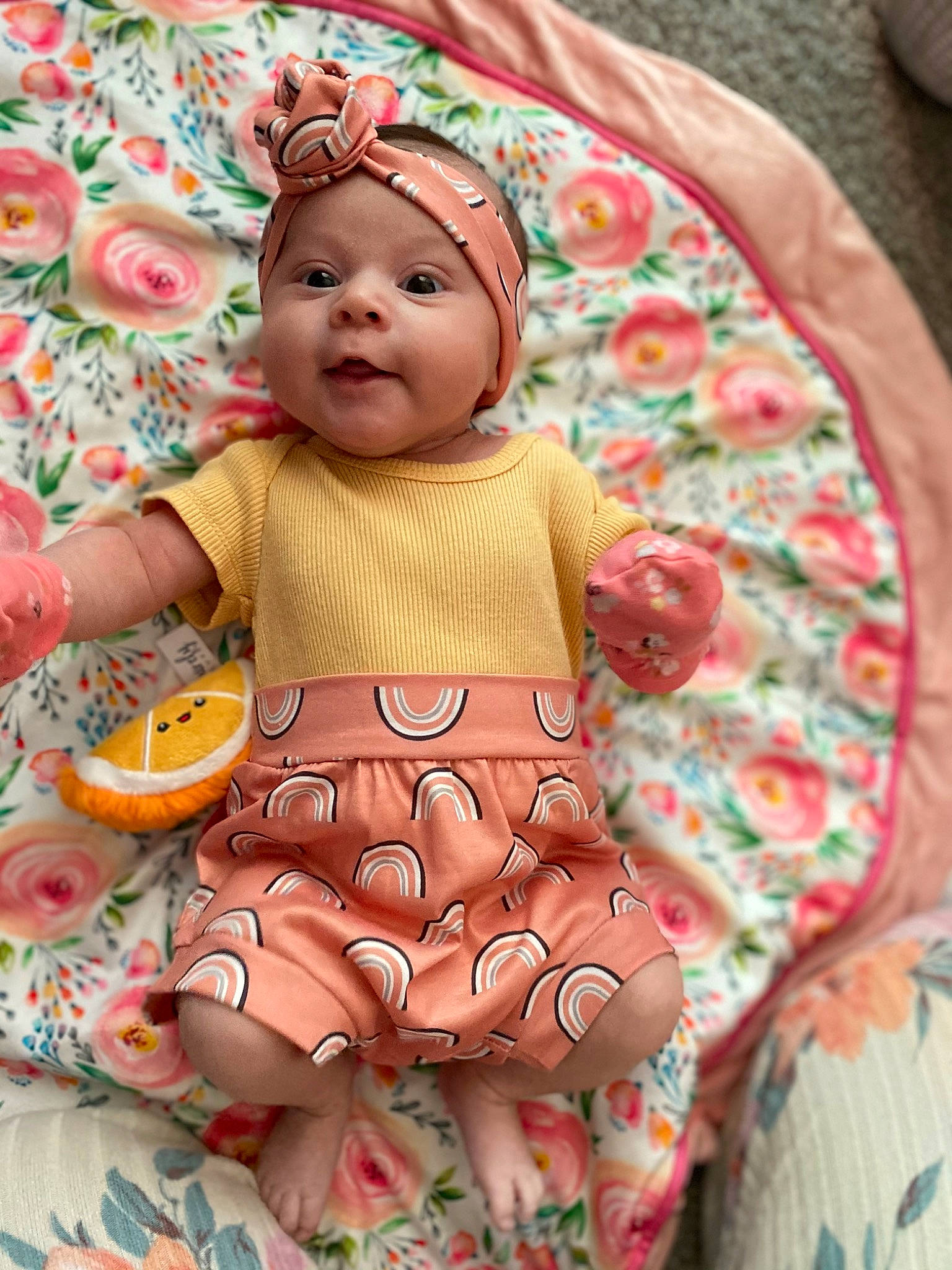 Marleigh joined the competition — help win amazing prizes! baby, baby_products, baby_toddler_clothing, cheek, child, doll, dress, eye, fawn, headwear, linens, orange, pattern, peach, person, pink, sitting, skin, sleeve, textile