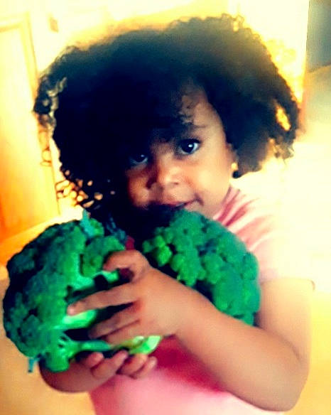 Taymazya Rozaye joined the competition — help win amazing prizes! afro, black_hair, child, cool, facial_expression, fashion_accessory, finger, fun, gesture, grass, happy, jheri_curl, nail, nose, person, petal, ringlet, thumb, toddler, wig
