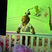 Kehlani joined the competition — help win amazing prizes! baby, crib, mobile, plush_toys, blanket, bedding, nursery, child, infant, furniture, room, standing, grip, clothing, toy, head, face, indoor, curious, colorful