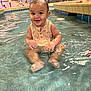 Zayvion joined the competition — help win amazing prizes! baby, child, clothing, face, feet, fun, happy, indoor_pool, legs, people_in_background, play, pool, relaxing, sitting, smiling, splashing, tiles, water, water_droplets, wet_skin