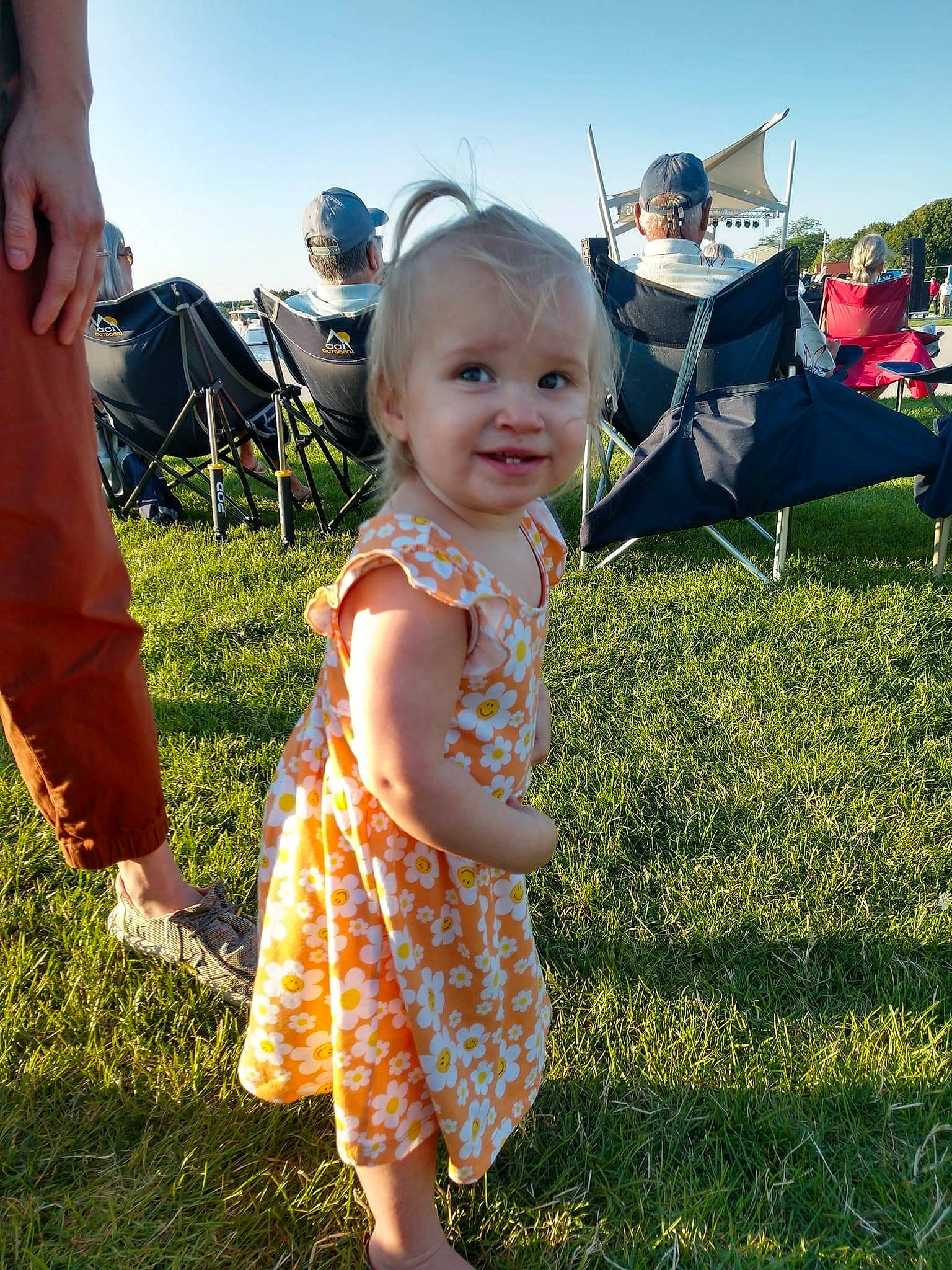 Maggie is registered to the contest to win money with this photo: chair, child, fun, gesture, grass, grass_family, grassland, happy, joy, leaf, leisure, meadow, morning, natural_environment, people, people_in_nature, person, recreation, sky, smile