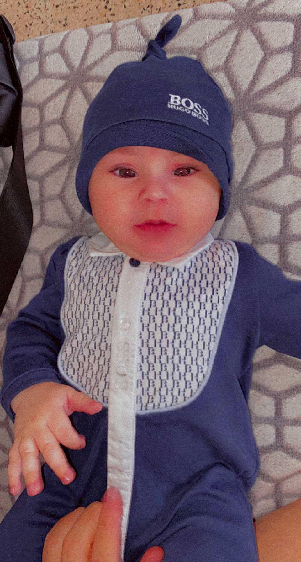 Jean-emmanuel a rejoint le concours — aidez-le/la à gagner de superbes lots ! baby, baby_toddler_clothing, cap, cheek, child, electric_blue, eye, grey, hand, headgear, headwear, knit_cap, lip, outerwear, pattern, person, sleeve, thumb, toddler, white