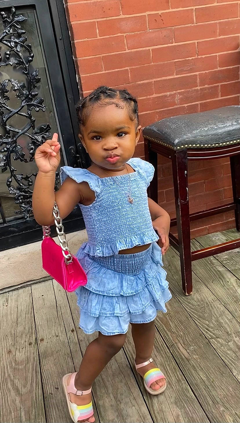 Kylann is registered to the contest to win money with this photo: baby_toddler_clothing, beauty, bench, child, electric_blue, fun, hand, happy, human_leg, joint, leisure, person, pink, sandal, shoulder, sitting, skin, standing, toddler, waist