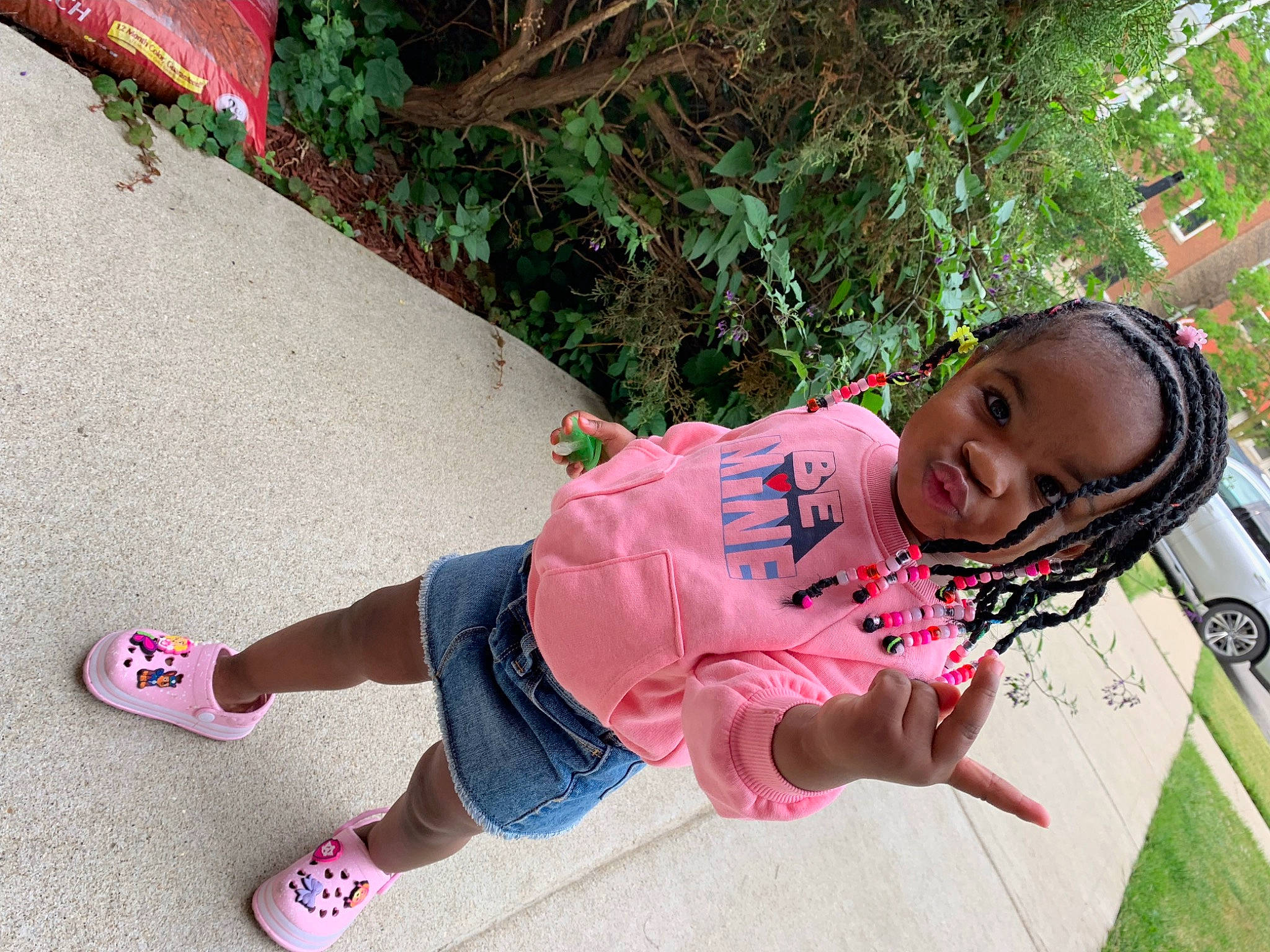 Kylann is registered to the contest to win money with this photo: baby_toddler_clothing, foot, fun, grass, happy, human_leg, knee, leisure, magenta, person, pink, plant, recreation, sandal, shoe, sitting, sneakers, sock, thigh, toddler