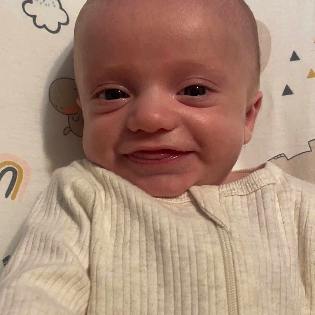 Kayson joined the competition — help win amazing prizes! baby, babylaughing, bodypart, clothing, coat, face, happy, head, jacket, knitwear, laughing, mouth, newborn, person, photography, portrait, shirt, smile, sweater, teeth