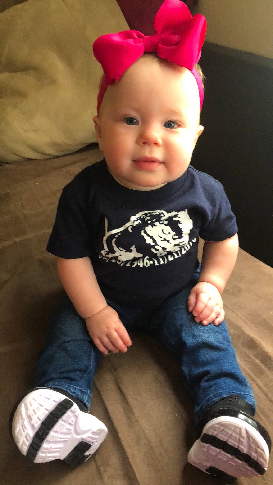 Emberlee is registered to the contest to win money with this photo: baby, baby_products, baby_toddler_clothing, cheek, child, cool, hair_accessory, headband, headgear, person, sitting, skin, sleeve, t_shirt, toddler