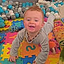 baby, ball_pit, child, clothing, colorful, crawling, cute, development, floor, foam_mat, happy, indoor, infant, necklace, person, playtime, puzzle, smiling, toys, young_child