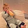 Edgard participe au concours pour gagner de l'argent avec cette photo : baby, bedding, bottle, child, clothing, comfort, cushion, cute, feeding, feet, indoor, infant, mesh, pajamas, person, playpen, red_hair, relaxing, sitting, young