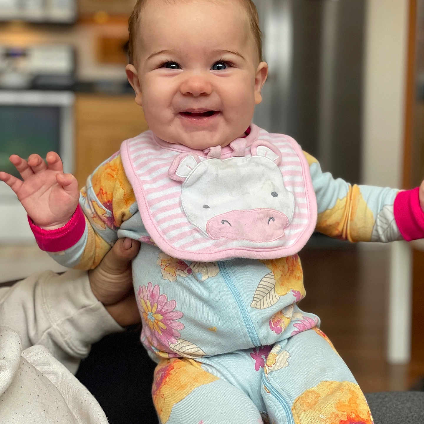 Oaklyn joined the competition — help win amazing prizes! baby, babylaughing, bib, bodypart, clothing, coat, face, finger, hand, happy, head, jacket, laughing, pajamas, pants, person, photography, portrait, sitting, smile