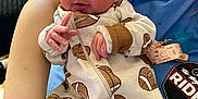 Wynter joined the competition — help win amazing prizes! baby, newborn, infant, headband, bow, onesie, football_print, eyes_closed, sleeping, hand, arm, caregiver, cup_with_straw, blanket, indoor, cozy, portrait, zipper, pattern, clothing