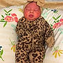 Wynter is registered to the contest to win money with this photo: baby, newborn, infant, sleeping, headband, bow, leopard_print, onesie, pillow, floral, hospital_bed, blanket, cute, closed_eyes, portrait, soft_toys_absent, nursery, skin, maternity, cozy
