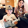 Paisley is registered to the contest to win money with this photo: child, baby, newborn, boy, girl, siblings, couch, indoors, family, smile, cap, tshirt, jeans, blanket, holding, portrait, happy, casual, home, cozy