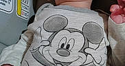 Gavin joined the competition — help win amazing prizes! baby, child, infant, smiling, laughing, face, portrait, car_seat, vehicle, safety_label, mickey_mouse, clothing, onesie, blanket, seated, indoor, close_up, happy, hand, photography