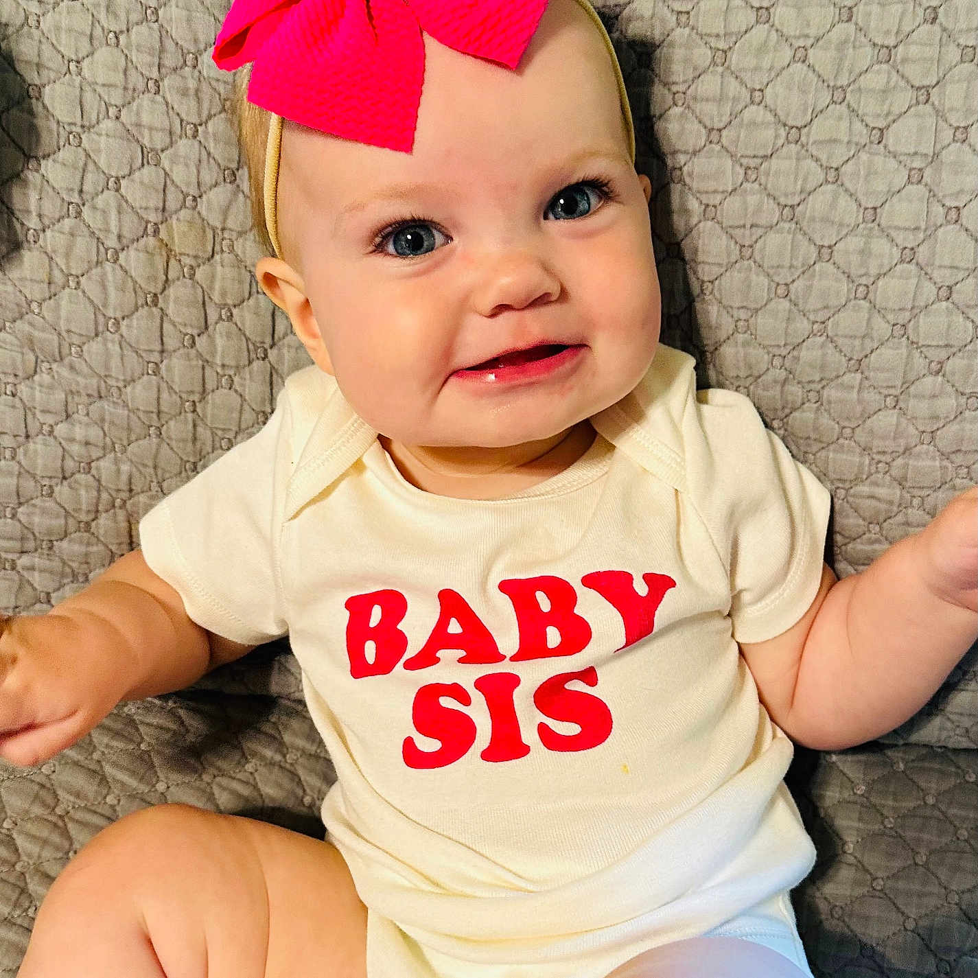 Kennedy is registered to the contest to win money with this photo: accessories, baby, clothing, couch, cushion, face, furniture, happy, hat, head, headband, homedecor, newborn, person, photography, portrait, sitting, sleeve, smile, t_shirt