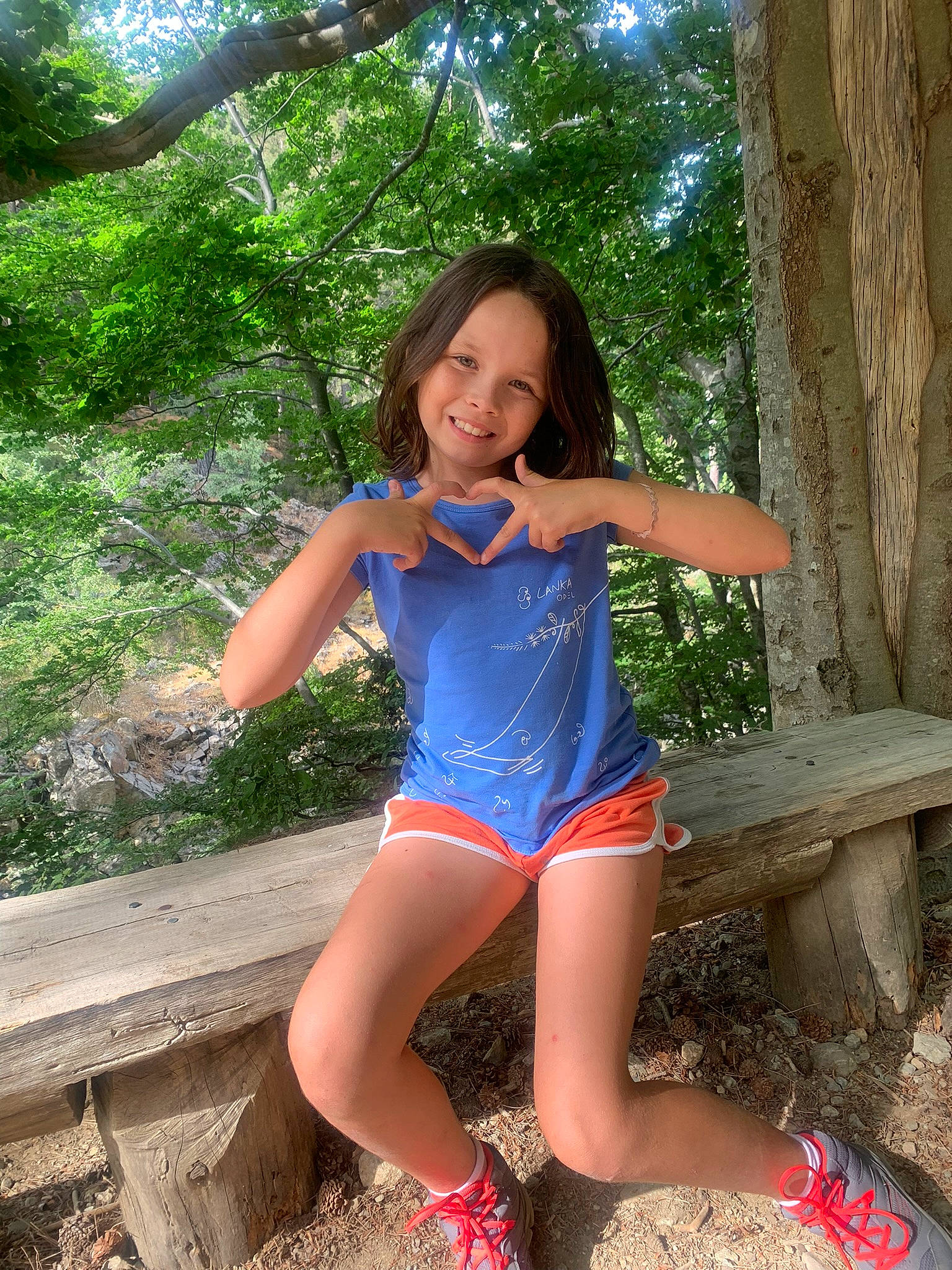 Janelle participe au concours pour gagner de l'argent avec cette photo : abdomen, black_hair, brown_hair, electric_blue, flash_photography, fun, grass, happy, human_leg, joy, knee, leisure, long_hair, people_in_nature, person, plant, sitting, smile, thigh, tree