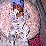 baby, infant, sleeping, pacifier, headband, bow, onesie, purple_flower, pink_cushion, crib, blanket, soft_texture, sleepwear, cute, child, resting, cozy, indoor, person, newborn