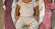 Milani is registered to the contest to win money with this photo: baby, baby_rocker, bow, carpet, child, comfortable, cute, footwear, headband, indoors, infant, moon, pajamas, person, plush_toys, relaxing, sleepy, sneakers, soft_lighting, star