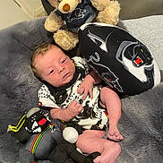 Dylan joined the competition — help win amazing prizes! newborn, baby, infant, plush_toy, teddy_bear, stuffed_animal, blanket, soft_texture, couch, indoor, clothing, cute, portrait, baby_girl, baby_boy, toy_panther, relaxing, resting, child, cozy