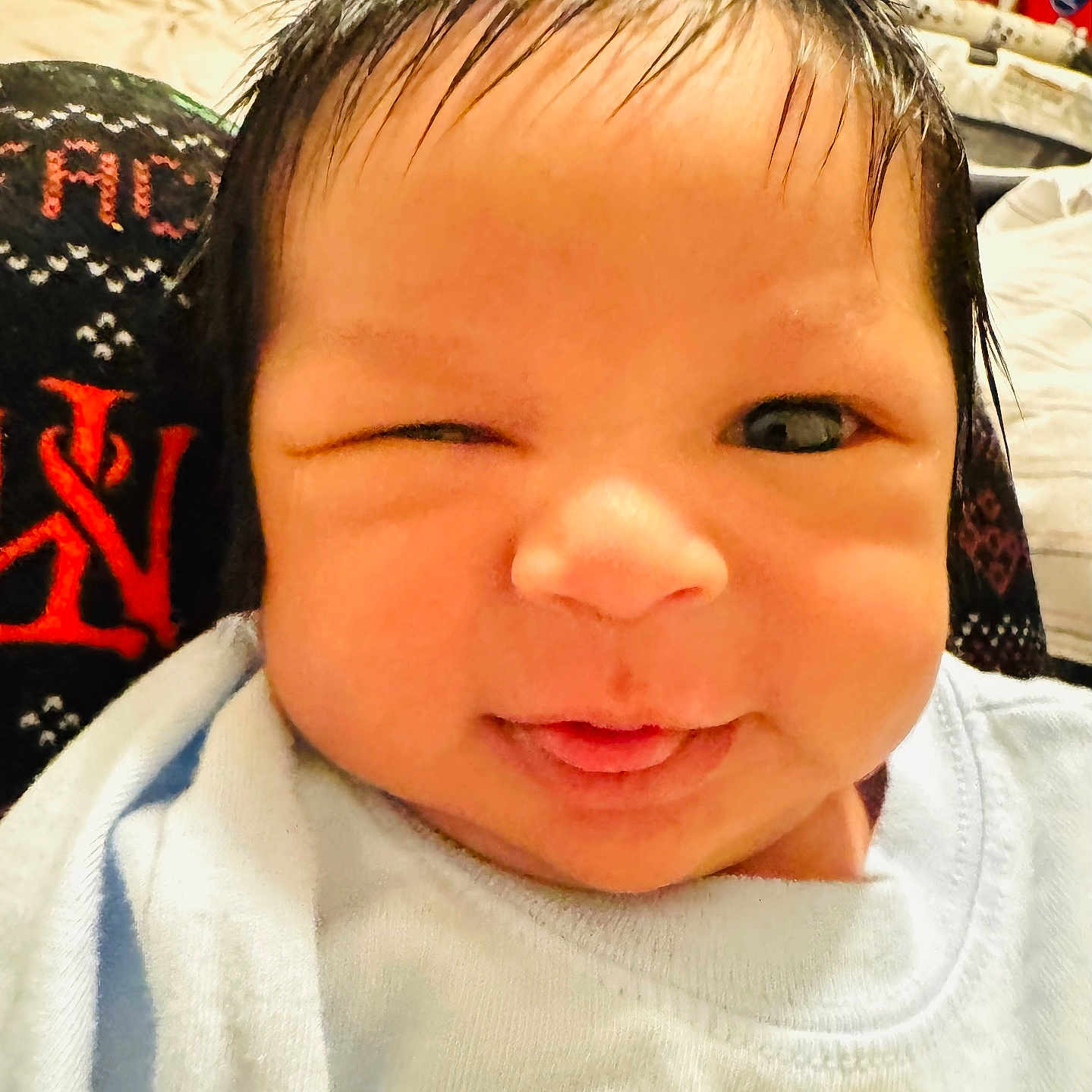 Haziel joined the competition — help win amazing prizes! baby, blue_shirt, child, close_up, clothing, cute, expression, face, human, indoor, infant, person, playful, portrait, skin, smiling, tongue_out, wet_hair, winking, young