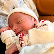 Oliver is registered to the contest to win money with this photo: newborn, baby, sleeping, smiling, hat, clothing, blanket, infant, cozy, soft, cute, peaceful, portrait, human, child, bedtime, resting, warm, closeup, indoors