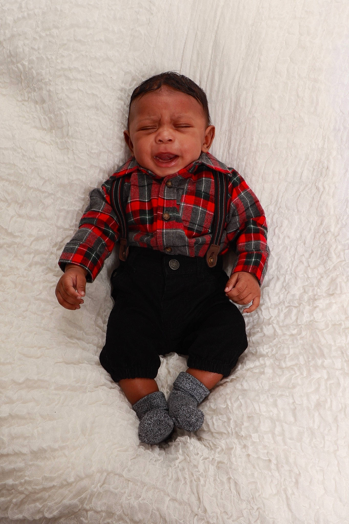 Armoni is registered to the contest to win money with this photo: ankle, baby, baby_toddler_clothing, cheek, child, comfort, foot, human_body, overall, pattern, person, plaid, shoe, sleeve, sock, tartan, textile, toddler