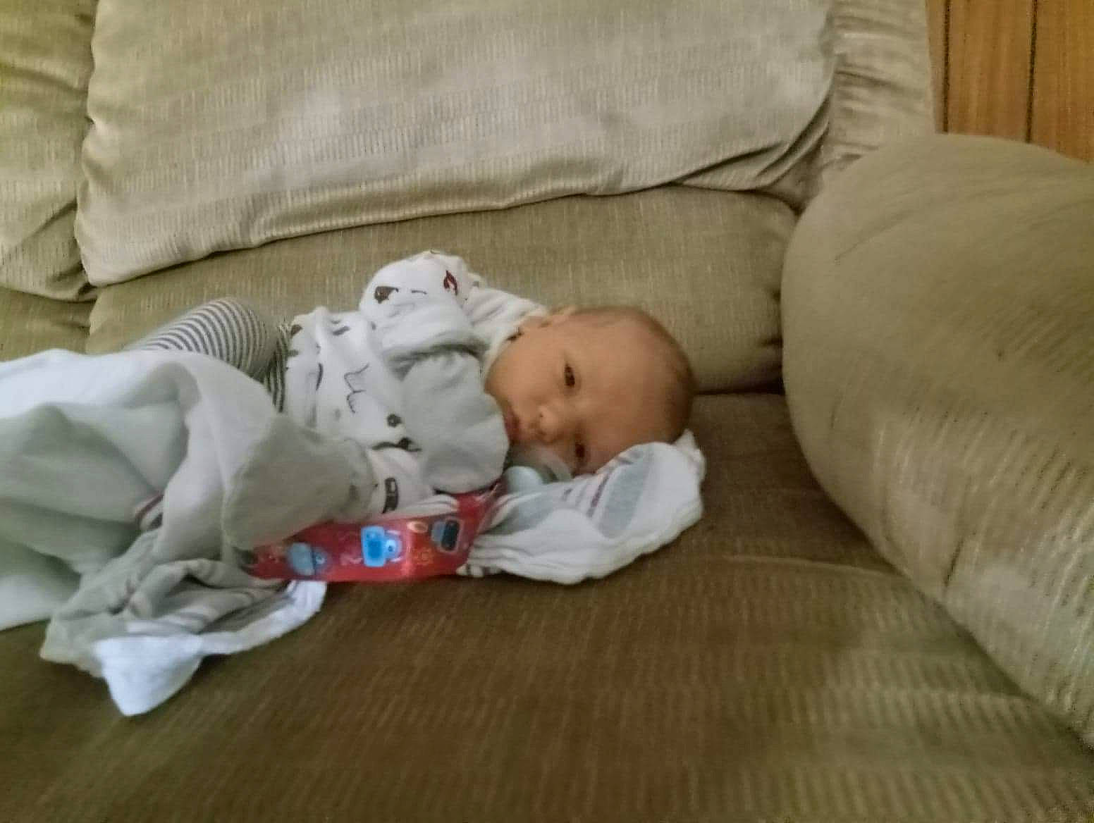 Brantley is registered to the contest to win money with this photo: baby, baby_products, baby_sleeping, baby_toddler_clothing, bedtime, child, comfort, couch, flooring, hardwood, linens, nap, person, room, sitting, sleep, toddler, wood, wood_flooring