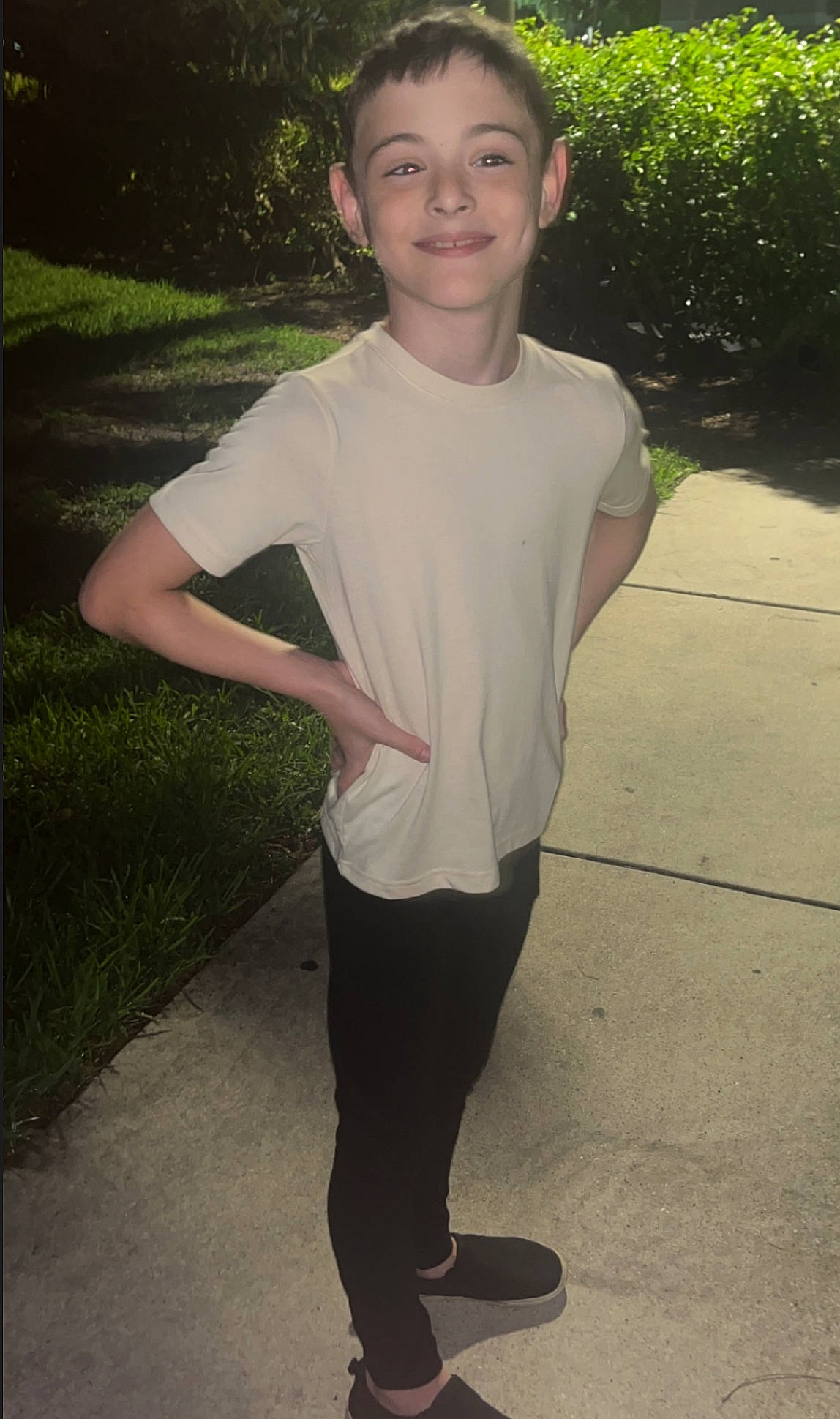 Kain is registered to the contest to win money with this photo: chest, eye, face, flash_photography, gesture, grass, happy, joy, knee, leg, leisure, neck, person, plant, sleeve, smile, sportswear, standing, t_shirt, thigh