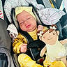 Ariani joined the competition — help win amazing prizes! baby, sleeping, car_seat, doll, yellow_clothing, headband, blanket, child, infant, toy, seatbelt, soft_toy, cute, resting, indoors, toddler, cozy, smiling_doll, fabric, comfort