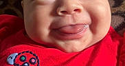 Ariani joined the competition — help win amazing prizes! baby, infant, face, smile, tongue, red_clothing, ladybug, pattern, leopard_print, cute, child, portrait, closeup, happy, skin, eyes, head, apparel, texture, person