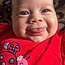 baby, infant, face, smile, tongue, red_clothing, ladybug, pattern, leopard_print, cute, child, portrait, closeup, happy, skin, eyes, head, apparel, texture, person