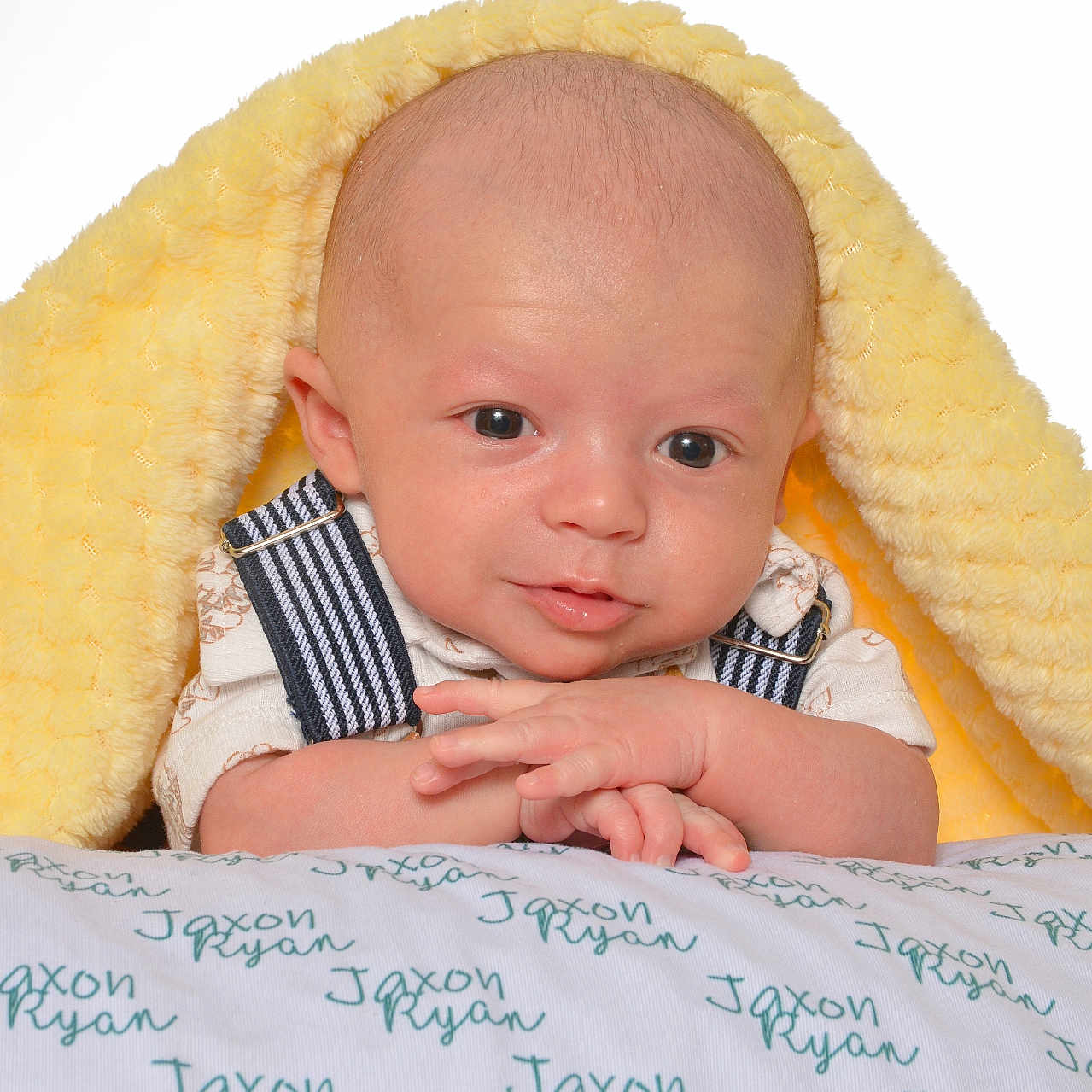 Jaxon is registered to the contest to win money with this photo: accessories, baby, blanket, bodypart, crib, cushion, face, finger, furniture, hand, head, homedecor, infantbed, newborn, person, photography, portrait, text, towel, wallet