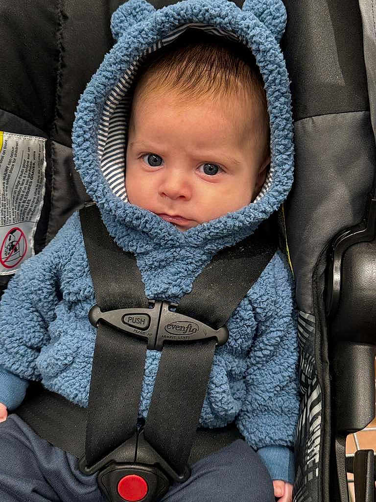 Thomas joined the competition — help win amazing prizes! baby, child, car_seat, blue_hoodie, straps, serious_face, indoor, person, infant, clothing, seatbelt, closeup, cute, expression, headwear, young, captive, portrait, baby_boy, warm_clothing