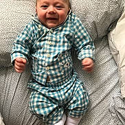 Alfie is registered to the contest to win money with this photo: arm, child, design, finger, hand, human_body, infant, interaction, leg, organ, pattern, person, sleep