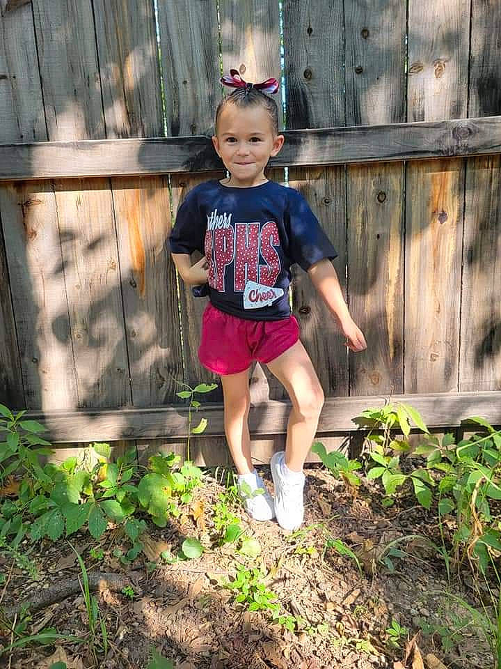Maizie joined the competition — help win amazing prizes! cool, eye, face, flash_photography, grass, green, hair, hairstyle, happy, hat, joy, morning, people_in_nature, person, plant, shorts, sunlight, t_shirt, thigh, toddler