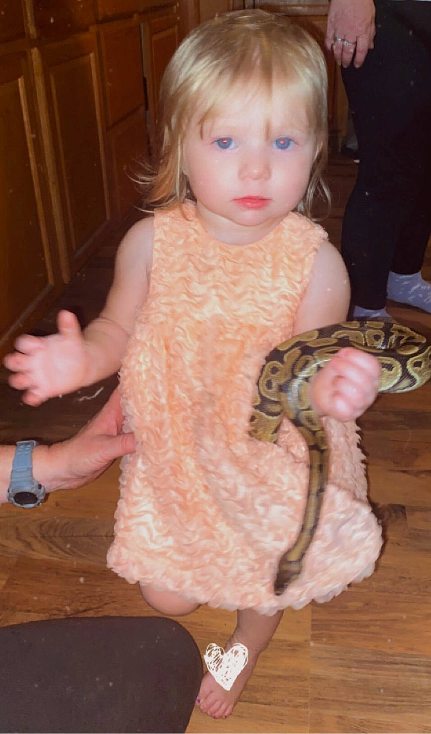 Raelynn joined the competition — help win amazing prizes! baby_toddler_clothing, cheek, child, eye, finger, hand, head, iris, pattern, person, pink, python, reptile, scaled_reptile, serpent, skin, sleeve, terrestrial_animal, thumb, toddler