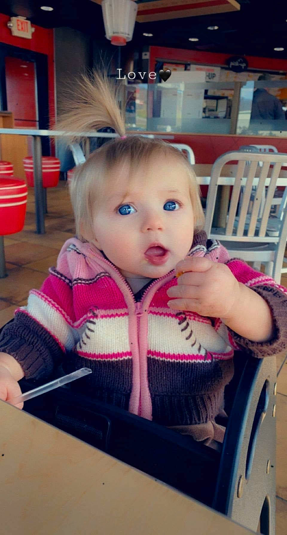 Raelynn joined the competition — help win amazing prizes! baby, baby_products, baby_toddler_clothing, chair, cheek, child, eyelash, facial_expression, fashion_accessory, fun, happy, iris, magenta, person, selfie, sitting, skin, sleeve, surprise, table