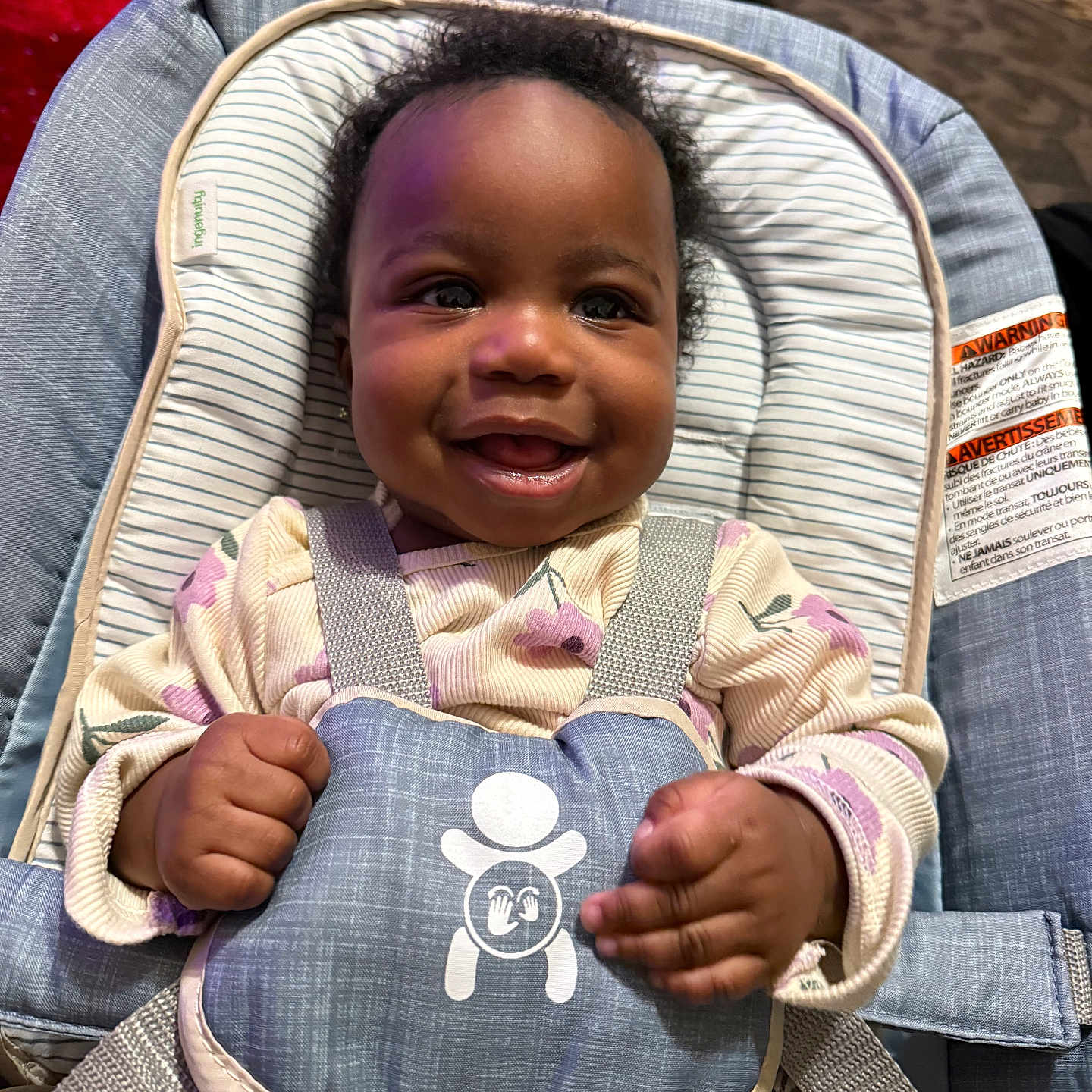 Ahzani is registered to the contest to win money with this photo: baby, baby_girl, baby_seat, carpet, child, clothing, cute, face, floral_pattern, hands, happy, indoors, infant, padded, person, safety, seat, smiling, straps, toddler