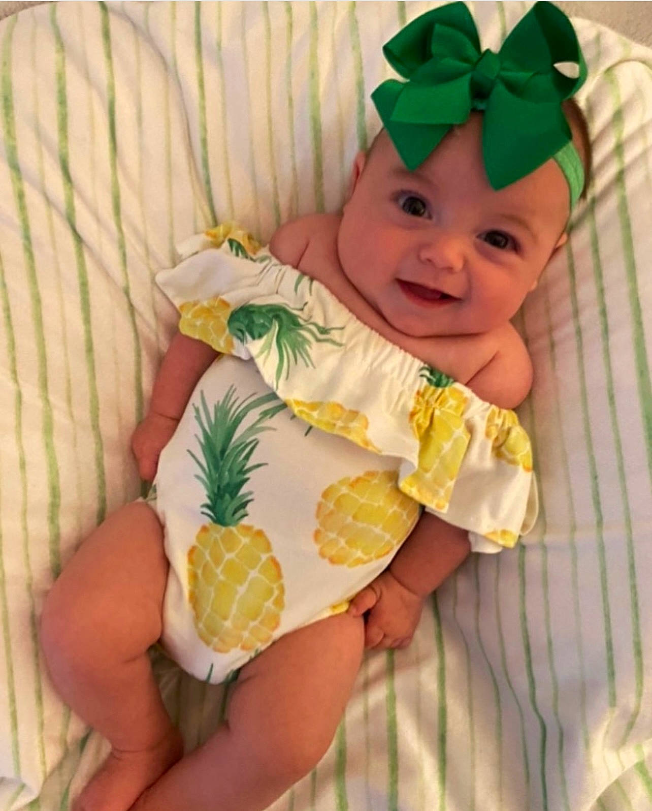 Laney is registered to the contest to win money with this photo: baby, baby_laughing, baby_products, baby_toddler_clothing, costume, costume_accessory, costume_hat, fictional_character, finger, fruit, hair_accessory, hand, headband, headpiece, headwear, linens, nail, person, stuffed_toy, thumb