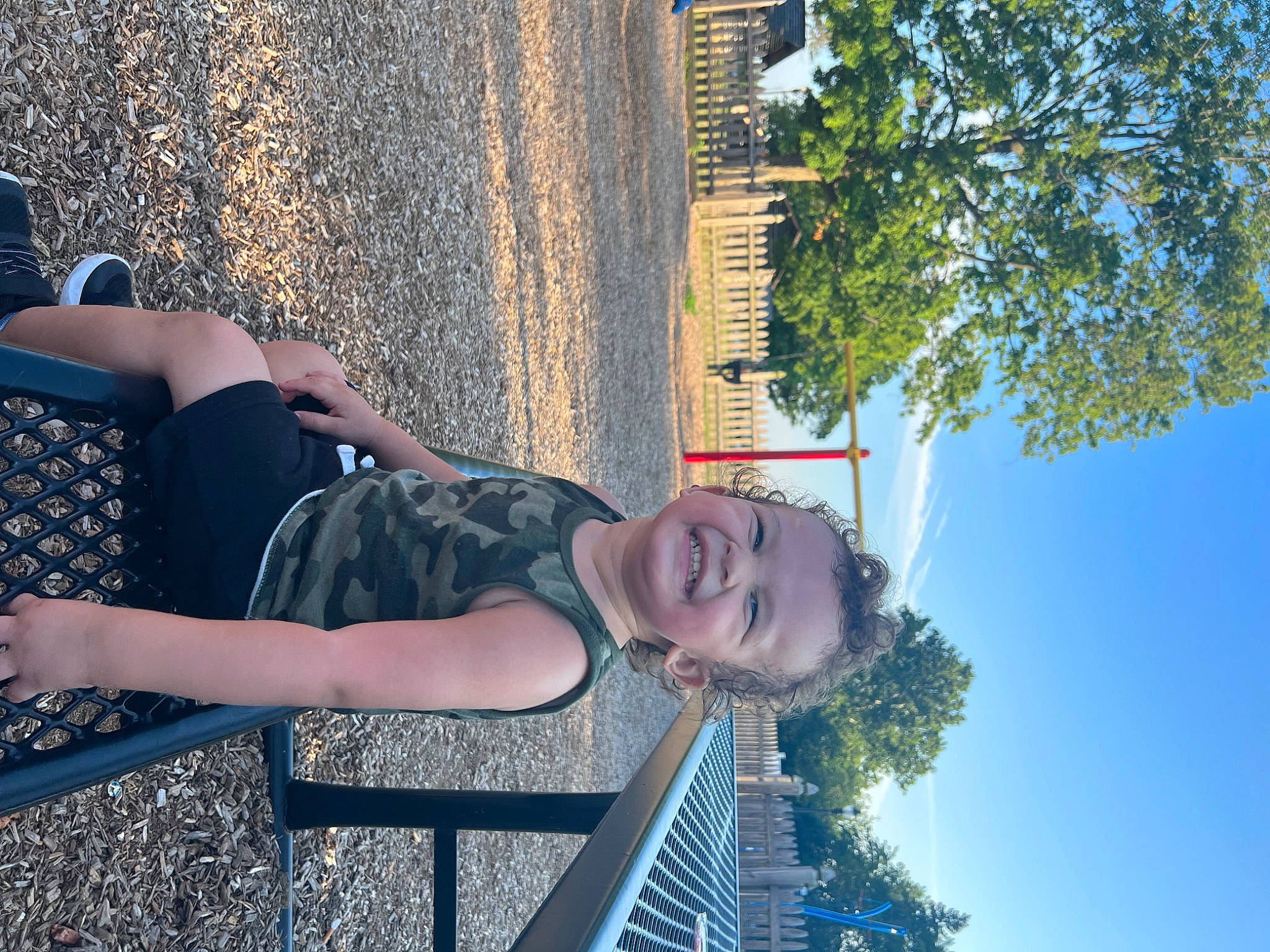 Esiah is registered to the contest to win money with this photo: azure, daytime, electric_blue, eyewear, fun, grass, happy, human_leg, joy, leisure, people_in_nature, person, sitting, sky, smile, summer, thigh, travel, tree, vacation