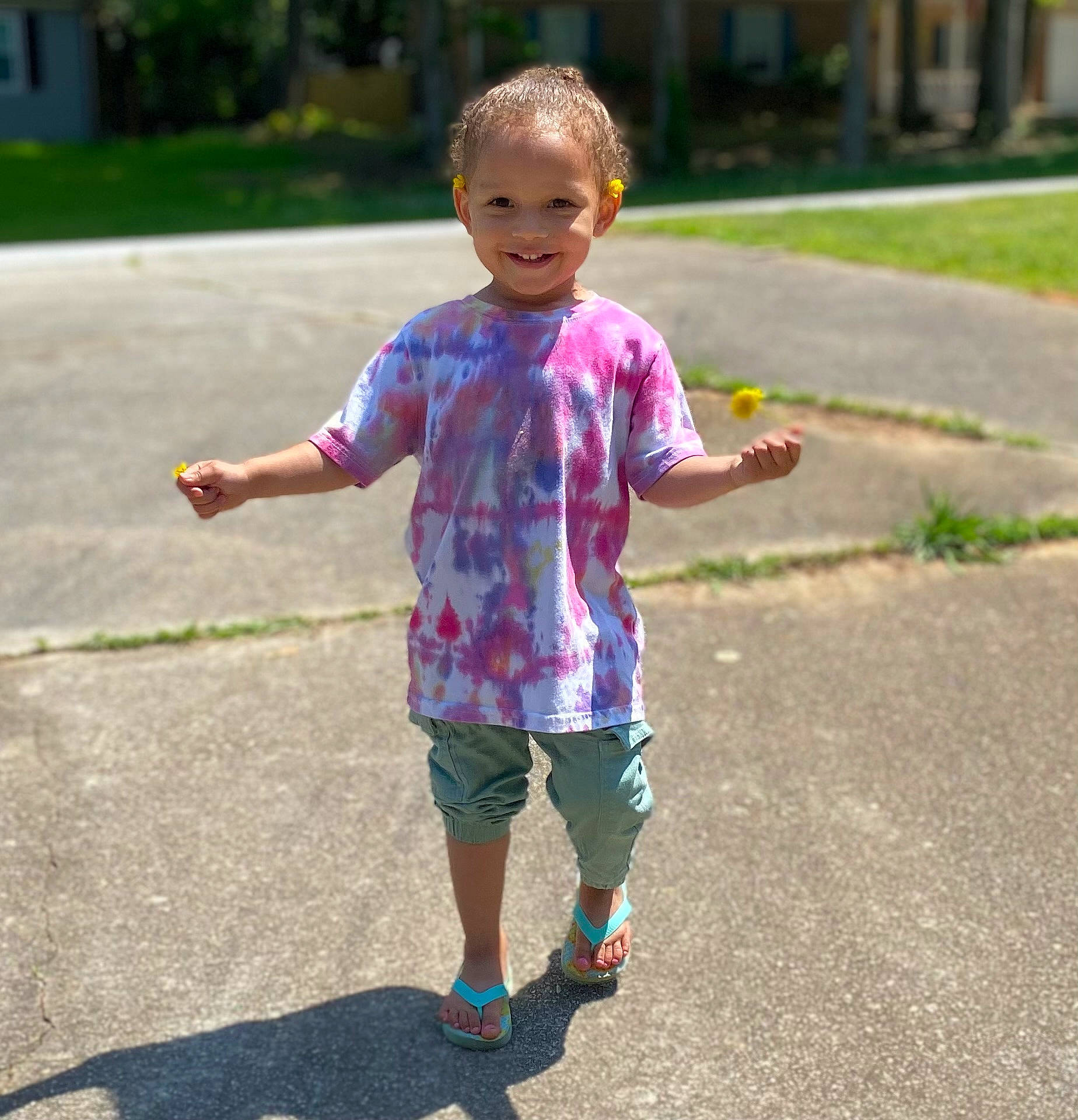 Alyna is registered to the contest to win money with this photo: asphalt, child, face, finger, gesture, grass, hand, happy, head, human_body, joint, joy, leisure, person, pink, plant, recreation, shorts, sleeve, smile