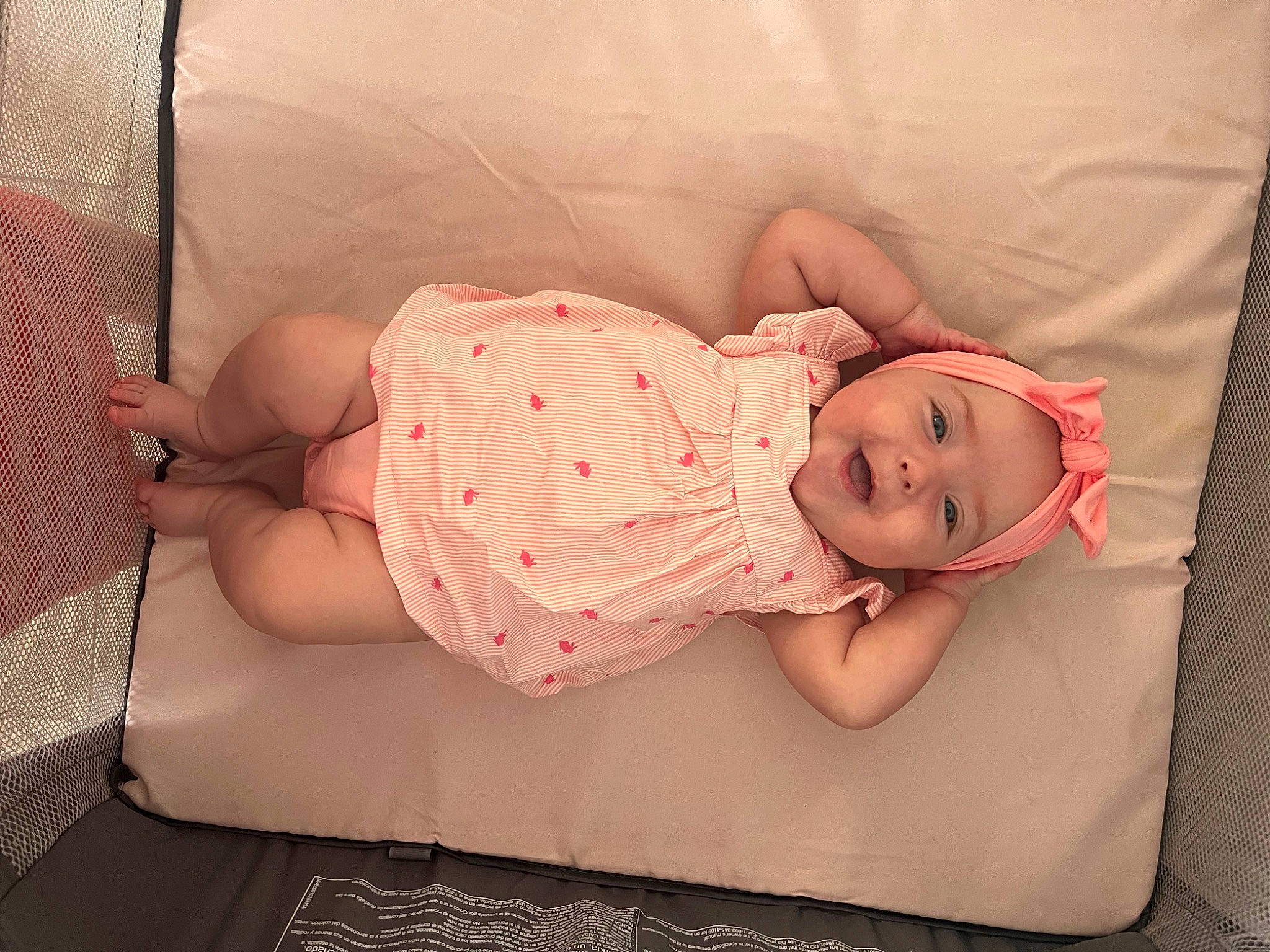 Elliana is registered to the contest to win money with this photo: arm, baby, baby_products, baby_sleeping, baby_toddler_clothing, child, comfort, finger, flesh, hand, headgear, headwear, human_body, linens, pattern, person, pink, room, skin, sleeve