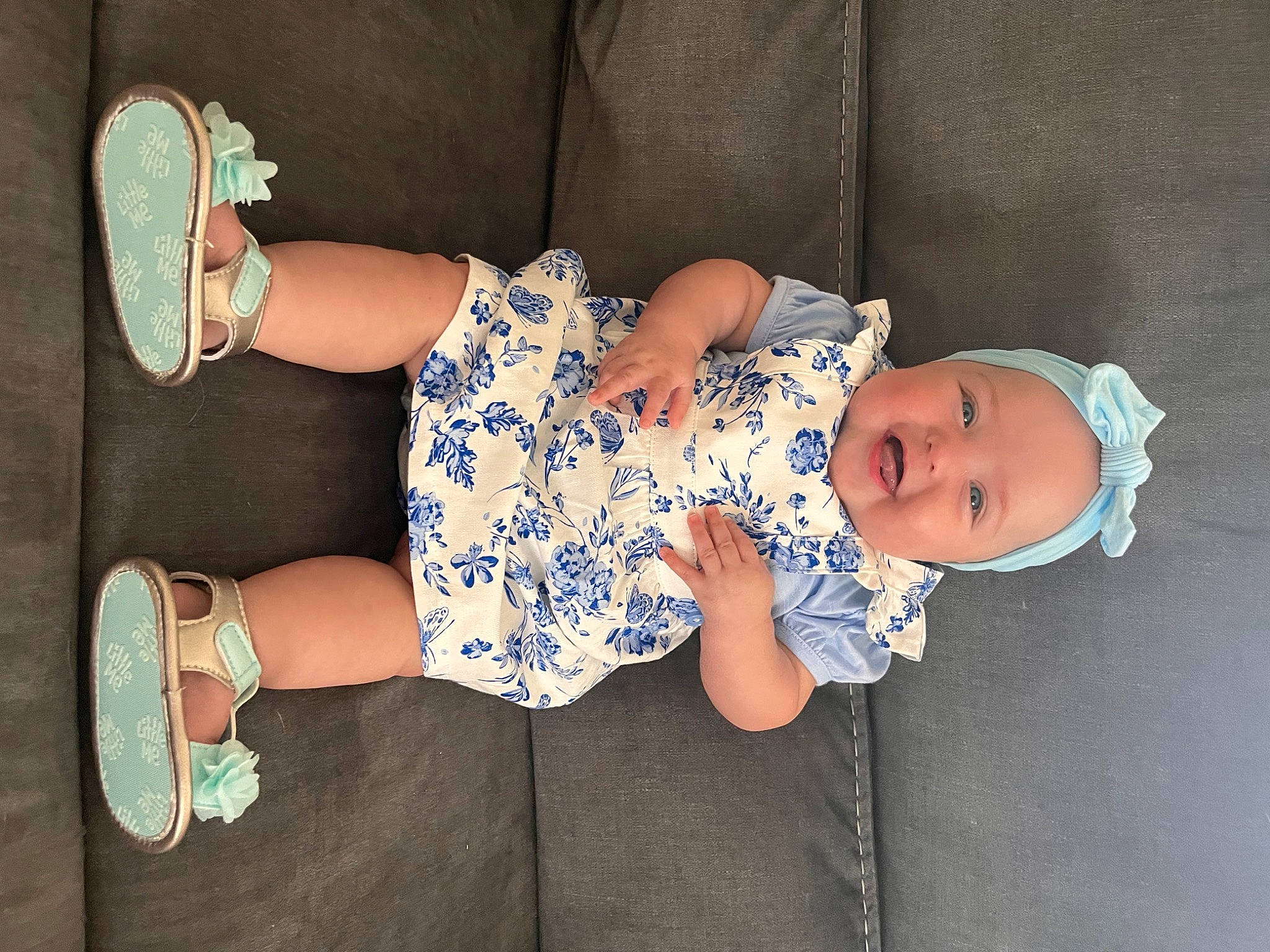 Elliana joined the competition — help win amazing prizes! arm, baby, baby_toddler_clothing, child, comfort, dress, electric_blue, finger, foot, glasses, hat, human_leg, joy, knee, leg, pattern, person, sitting, sleeve, thigh