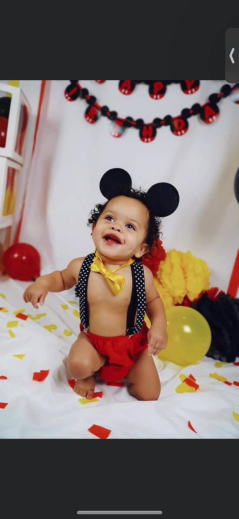 Kayden is registered to the contest to win money with this photo: arm, baby, balloon, child, entertainment, event, finger, fun, happy, headgear, jewellery, orange, party_supply, performing_arts, person, red, skin, smile, thigh, toddler