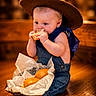 baby, child, food, bread, sandwich, hat, denim, overalls, blue_bandana, sitting, indoor, wood_floor, basket, cute, eating, portrait, infant, chubby_cheeks, appetizer, clothing