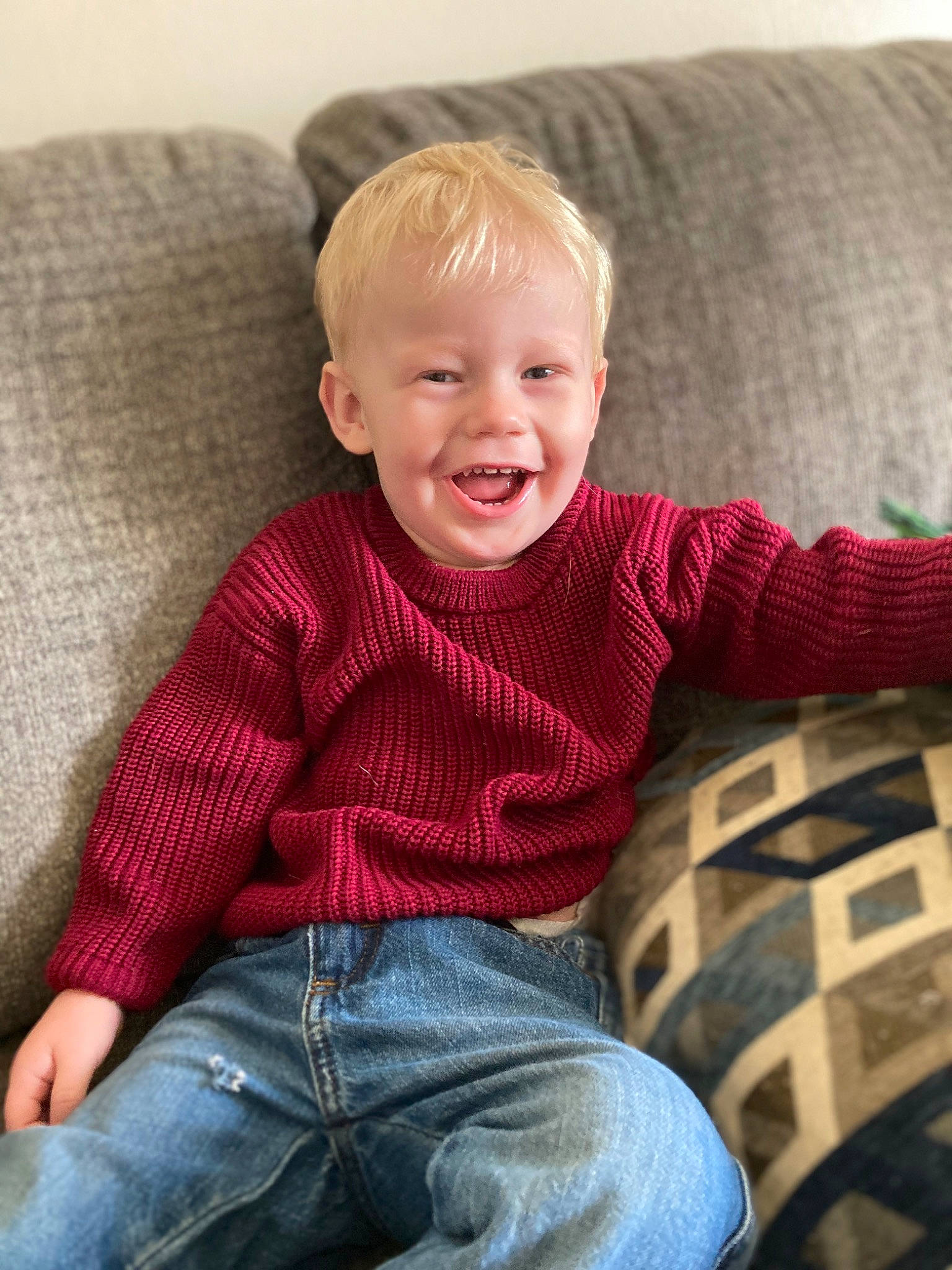 Mikey joined the competition — help win amazing prizes! baby_toddler_clothing, child, comfort, couch, furniture, hair, happy, human_body, jeans, joy, lap, leg, pattern, person, plaid, sitting, skin, sleeve, smile, textile